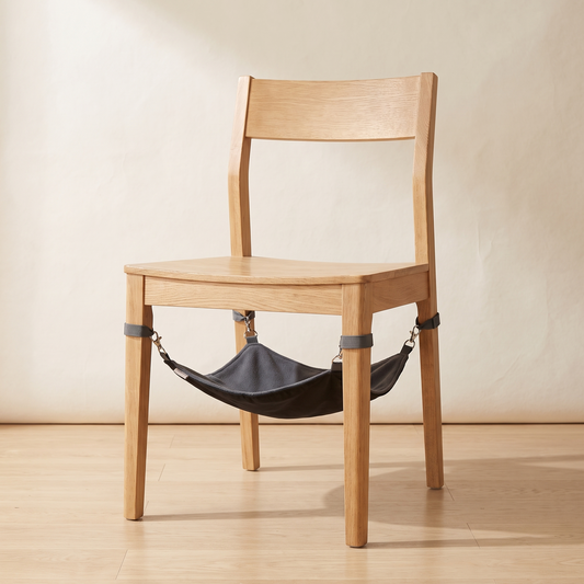 Black cat hammock bed clipped under a wooden chair